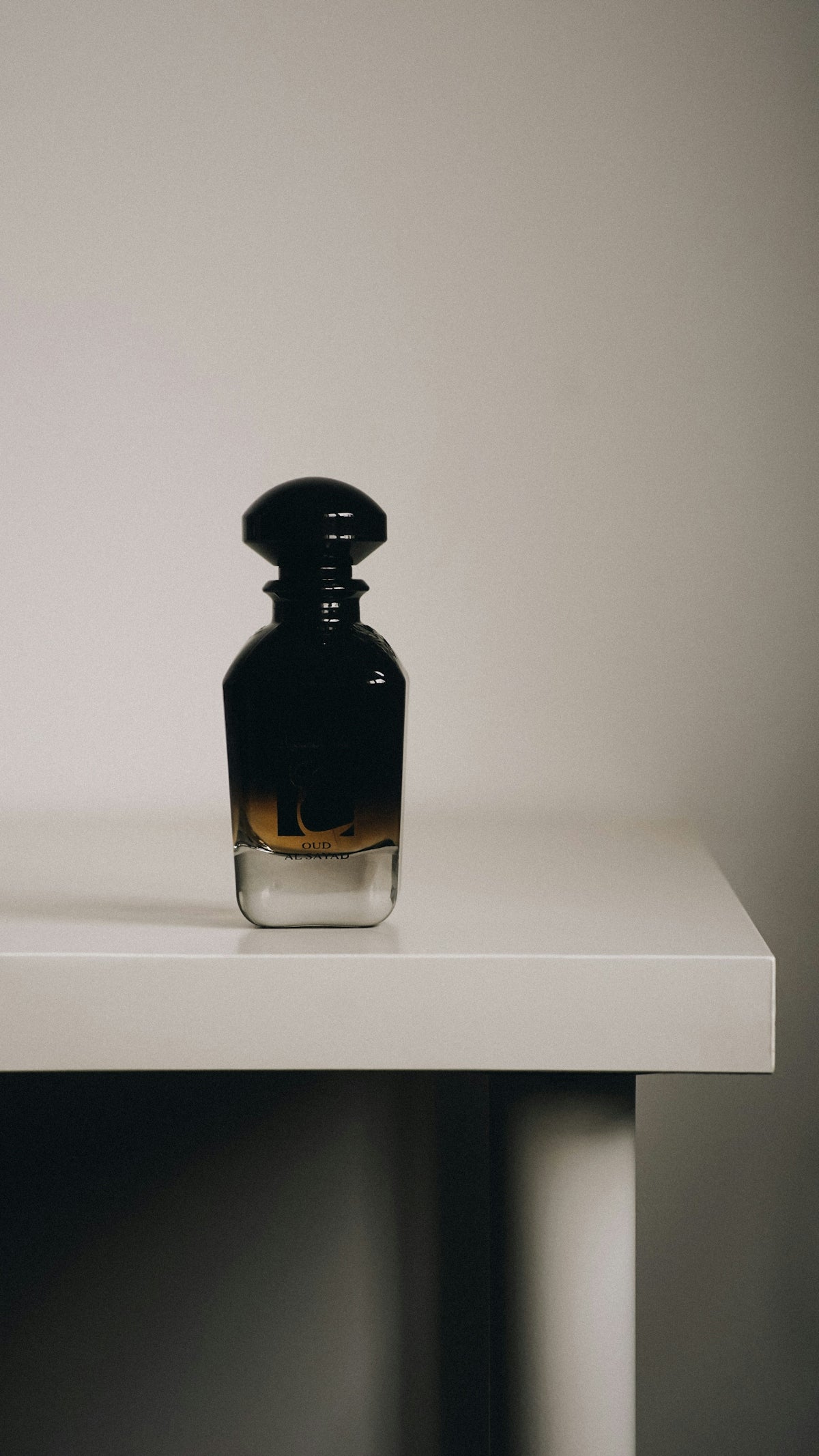 a bottle sitting on top of a white table