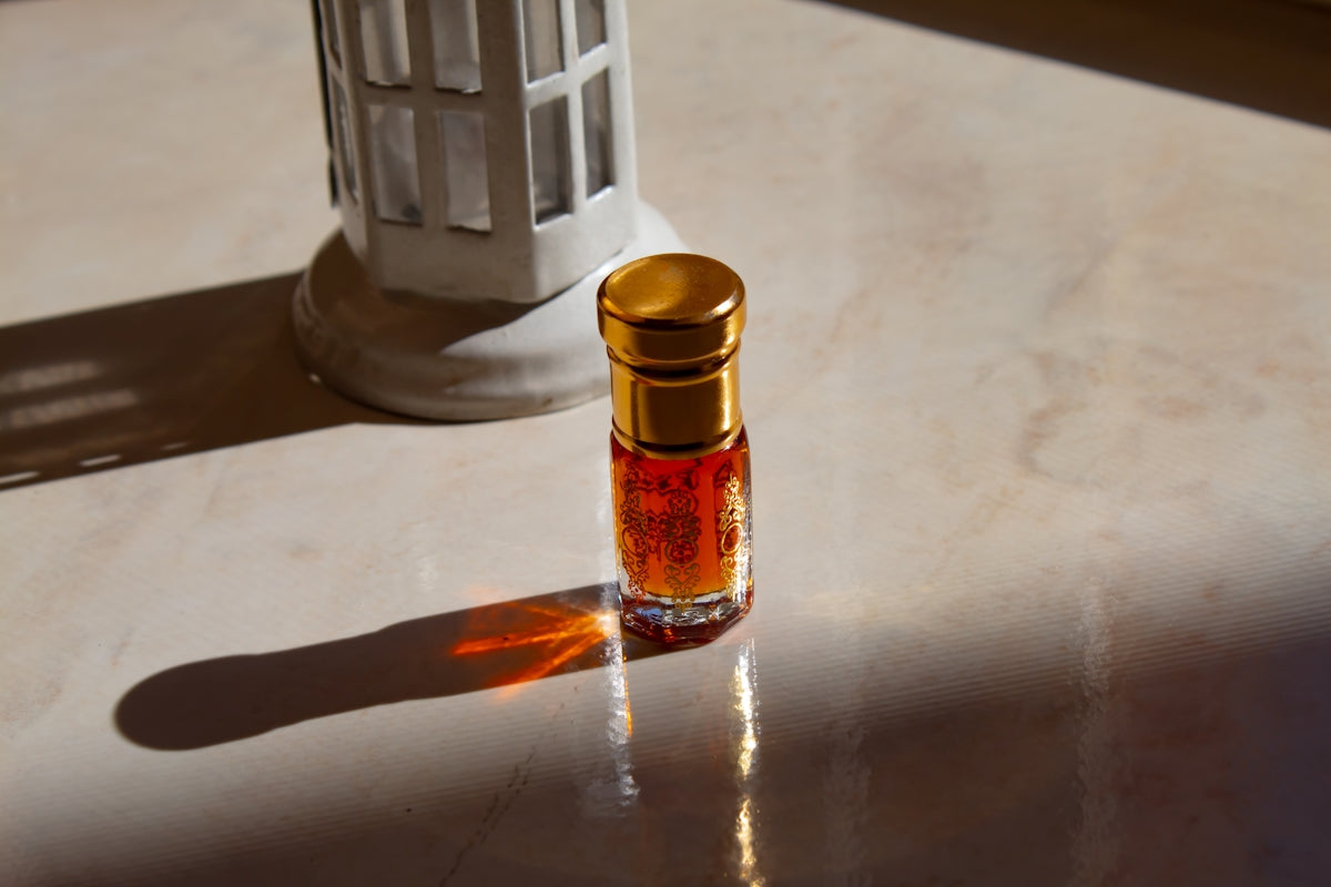 A small bottle of perfume sitting on a table