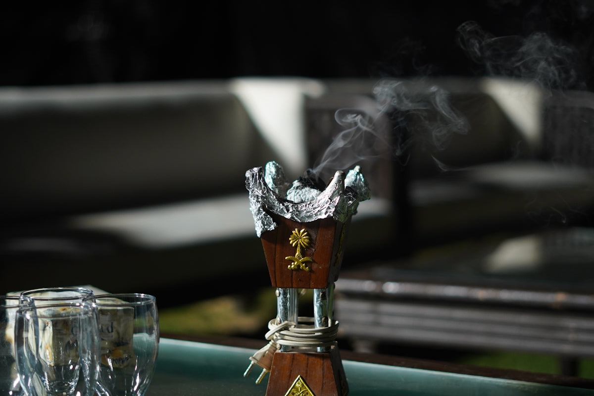 Burning incense emits smoke in a modern setting.